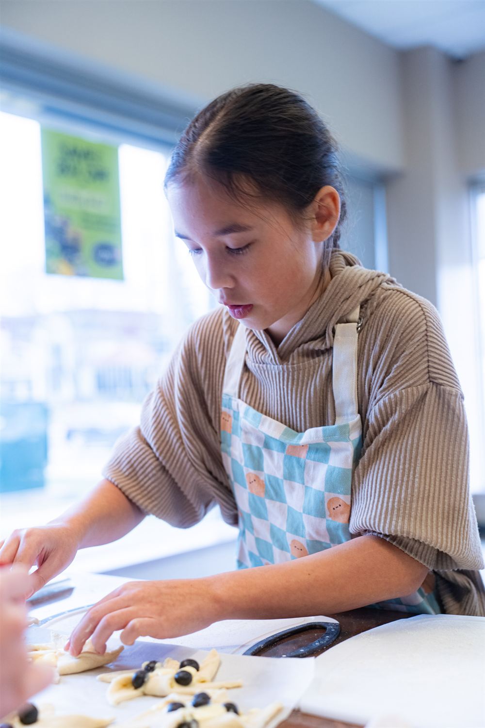 Student preparing pastry in the Monthly Cooking School